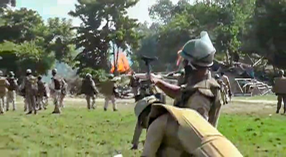 Darrang: Police attempt to disperse protestors during an agitation against an eviction drive, in Darrang district, Thursday, Sept. 23, 2021. (PTI Photo)